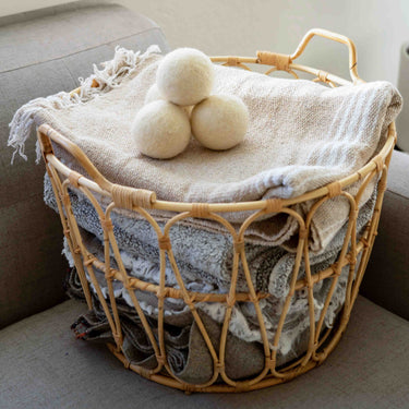 A basket of freshly folded blankets after being washed and dryed with sustainable wool dryer balls