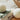 Eco-friendly wool dryer balls on sage green and white organic linens showing natural texture and sustainable laundry care alternatives to fabric softeners