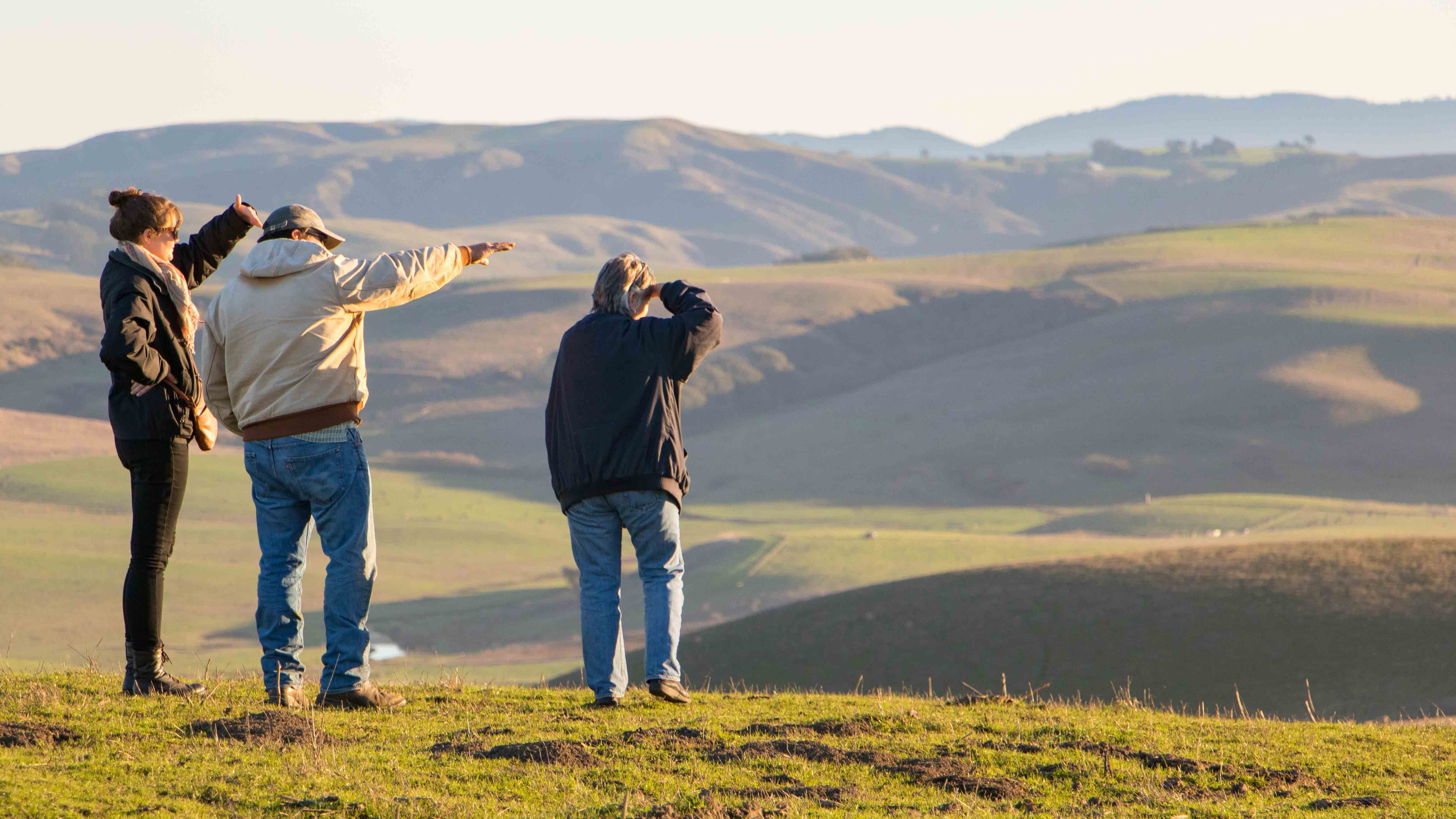 Still image from video showing ranchers overlooking rolling California hills