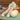 Close up of two different types of wool dog toys on a wooden table