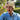 A wool watch cap on a man's head in a garden