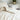 Plush white wool comforter with natural wrinkles against a light background, showcasing premium organic bedding that promotes healthy sleep with temperature-regulating merino wool
