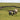 Four sheep grazing on lush green grass in an expansive field under a bright blue sky. 