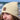 Close up of a wool beanie being worn by a woman the beach